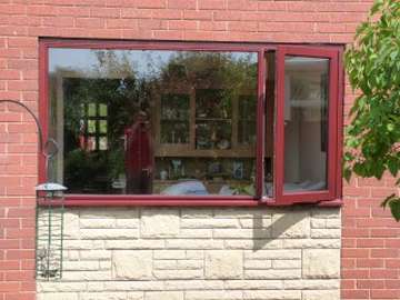 NESTON. CHSHIRE . Installtion of G. barnsdales Timber window fabricated in Red Gradis Hardwood, stained Mahogany to match existing Hardwood frames. All Timber windows and doors Come pre painted or stained